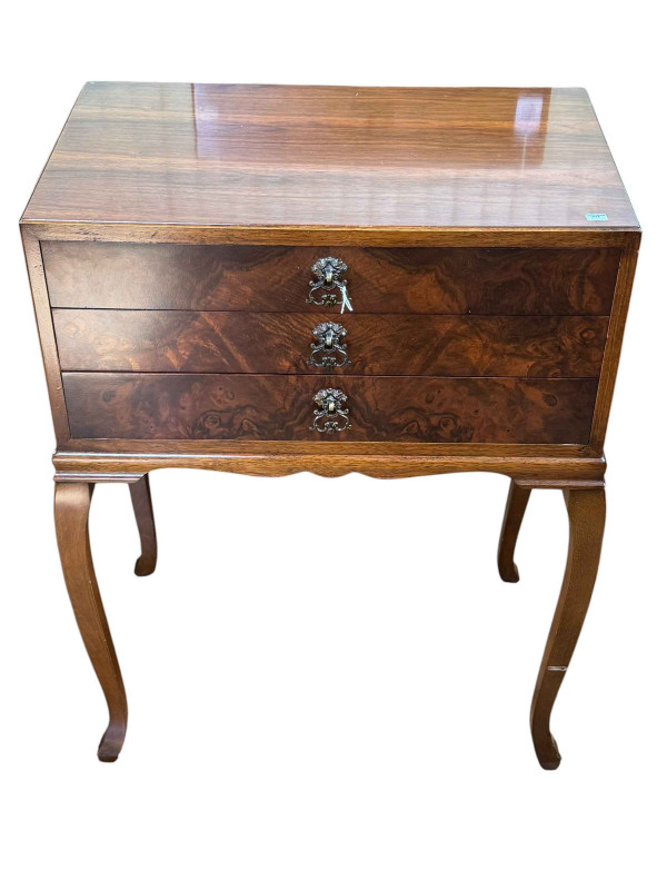 Walnut three drawer pedestal with cutlery.
