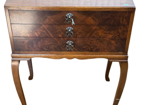 Walnut three drawer pedestal with cutlery.