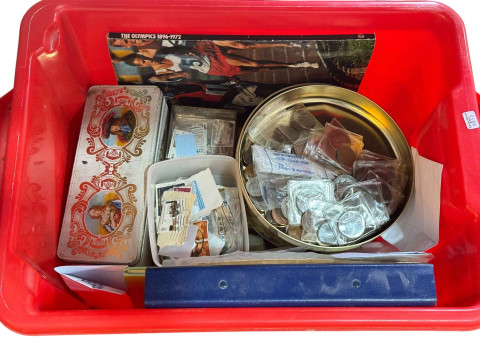 Box of assorted coins and stamps.