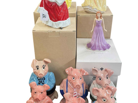 Four Royal Doulton ladies and seven Wade Nat West piggy banks.