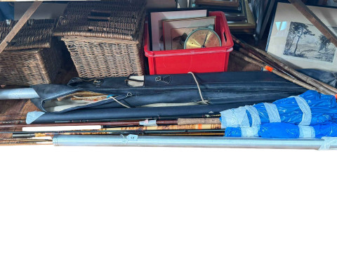 Large collection of fishing equipment including various rods, lures, fly...