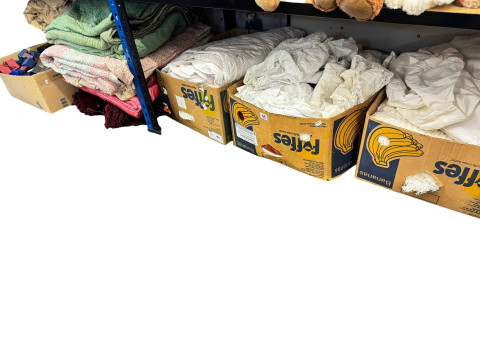Four boxes of linen, quilts, Victorian clothing and jewellery boxes, and...
