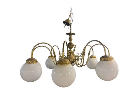 Large brass eight branch chandelier with opaque globe shades.