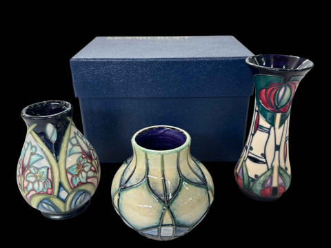 Three small Moorcroft vases with one box, tallest 12.5cm.