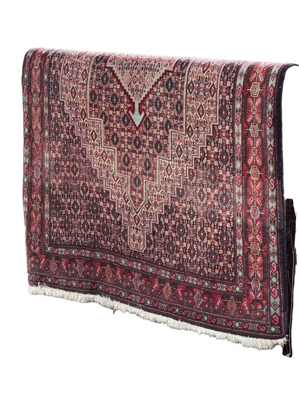Red ground Persian wool rug, 167cm by 126cm.