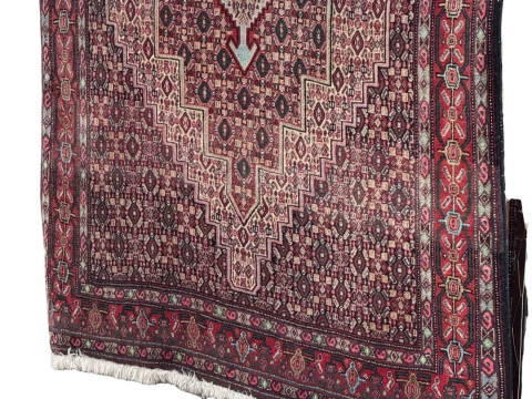 Red ground Persian wool rug, 167cm by 126cm.