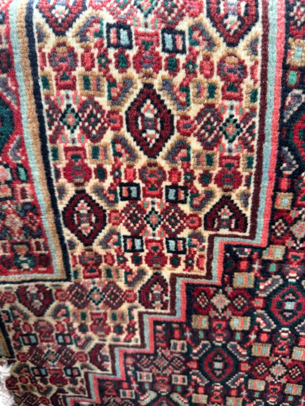 Red ground Persian wool rug, 167cm by 126cm.