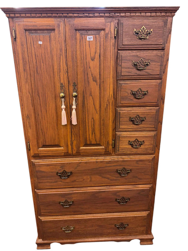 Oak cabinet having a double cupboard beside four small drawers above three long drawers on bracket feet and small two door cupboard (large cabinet 97cm by 171cm by 44cm).