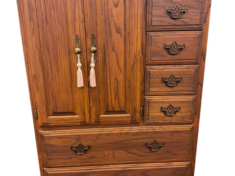 Oak cabinet having a double cupboard beside four small drawers above three...