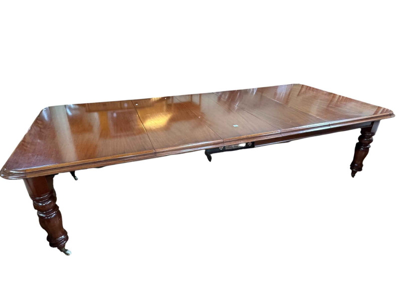Victorian style mahogany extending dining table raised on turned legs with three leaves, 162cm by 129cm by 76cm (297cm with leaves).