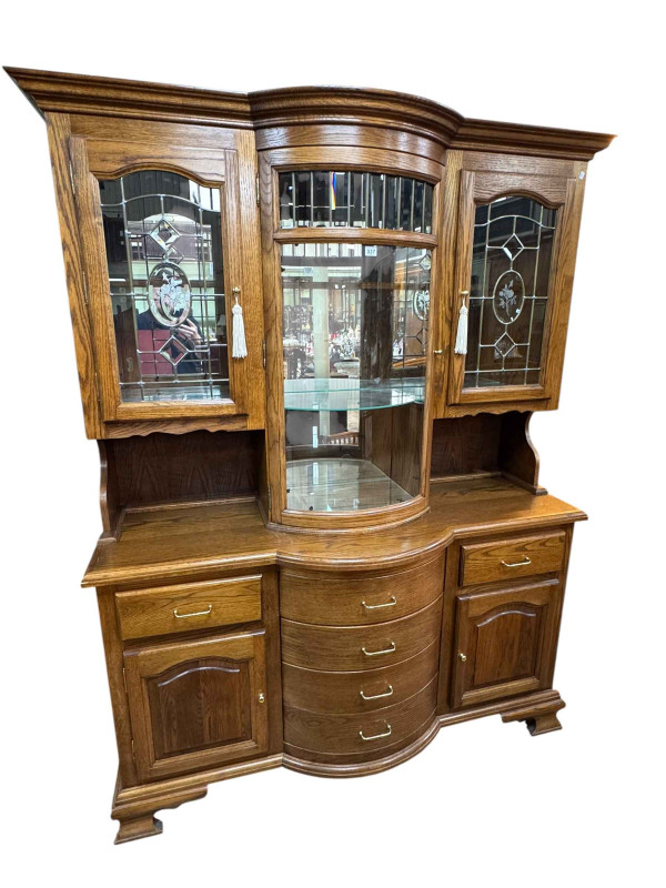 Oak bow front dresser with triple glaze door top above four central drawers flanked by two frieze drawers and cupboards on bracket feet, 156cm by 196cm by 56cm.