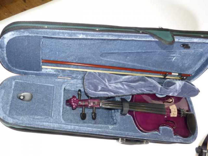 Cased Cathedral purple violin.