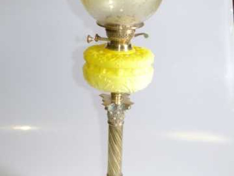 Brass twist corinthian column oil lamp with moulded yellow glass reservoir...