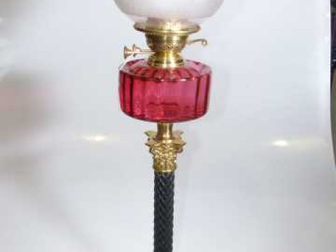 Brass and ebonised wood corinthian column oil lamp with ruby reservoir...