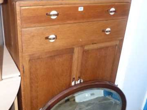 1930's oak two drawer linen cupboard and two oval framed wall mirrors...