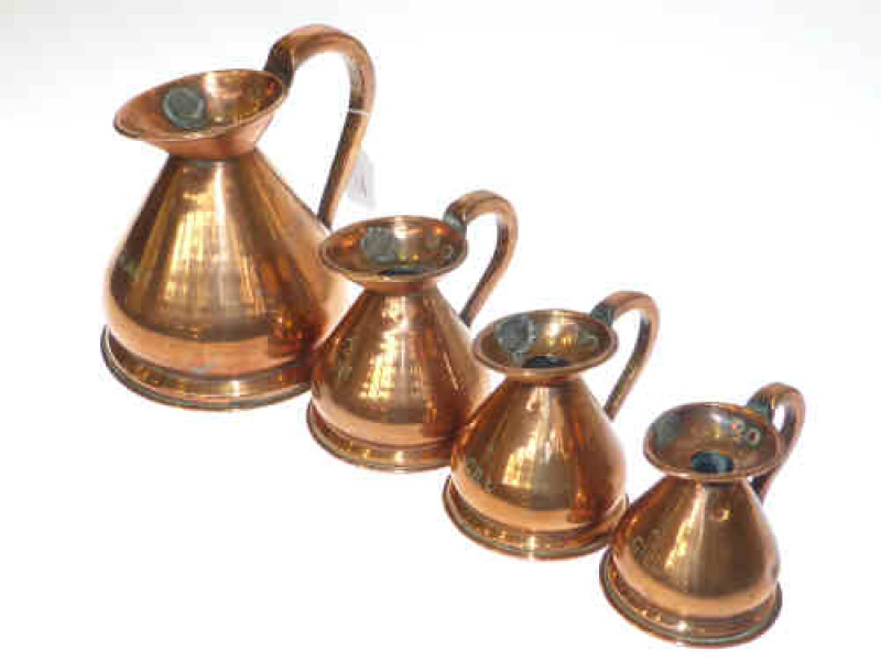 A set of four graduated copper measures