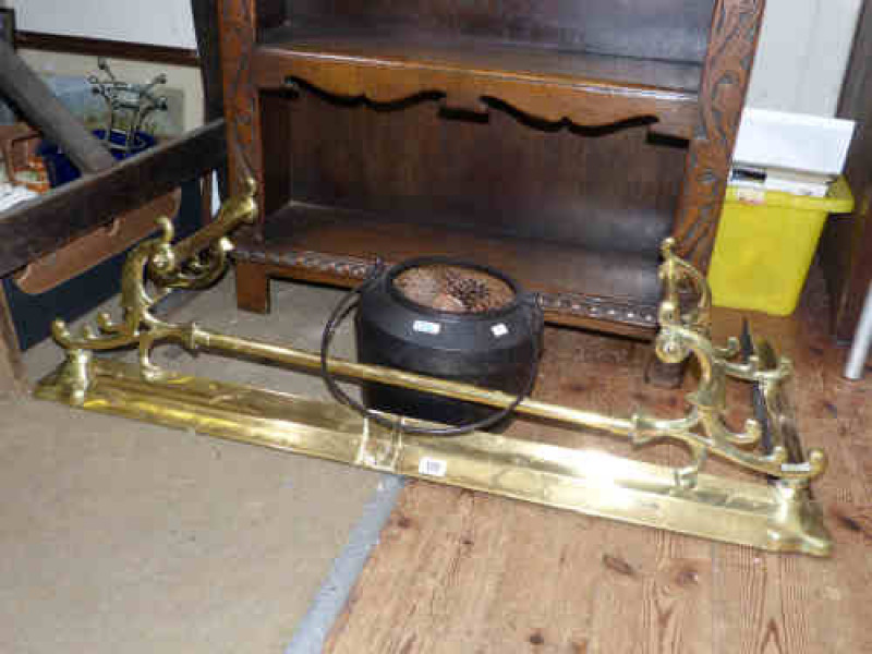 Brass fender and a metal cooking pot