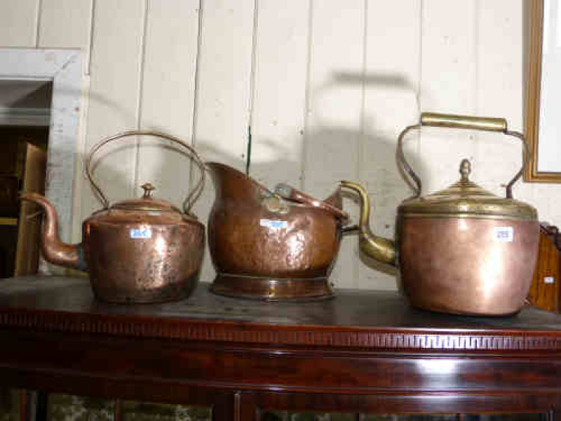 Two Victorian copper and brass kettles and copper swing handled coal helmet