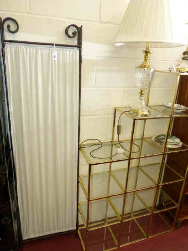 Gilt and glass shelving display unit and three-fold iron and fabric vanity screen