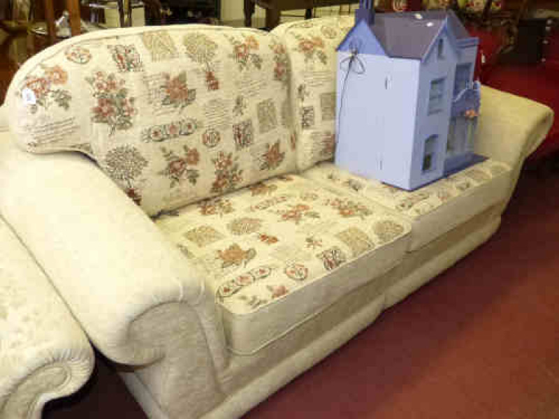 Two seater settee in beige and floral patterned fabric