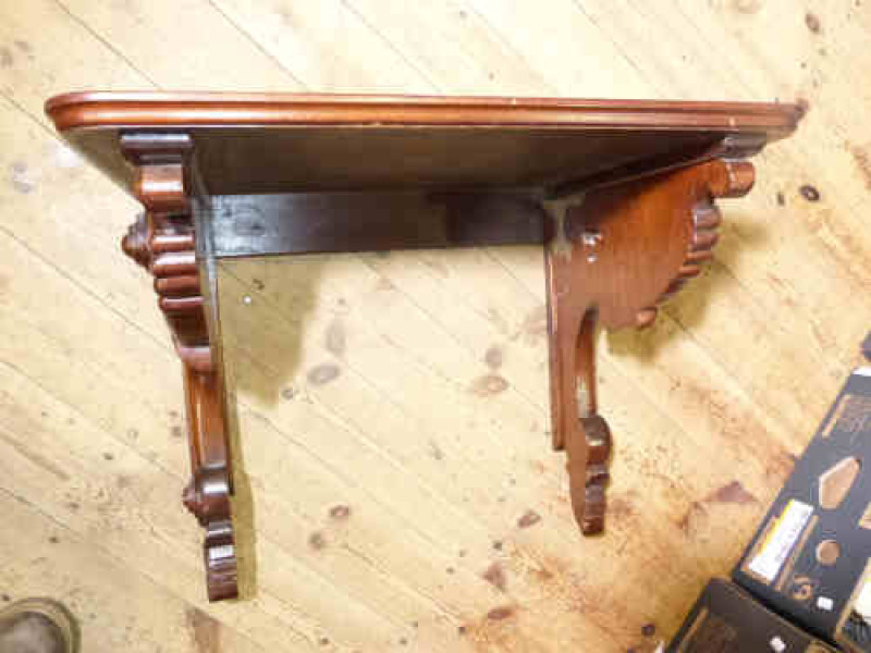 Mahogany wall bracket with carved scroll supports