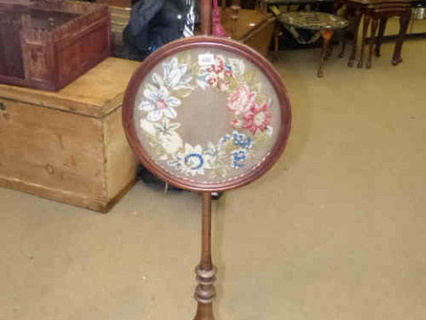 Regency mahogany pole screen on three claw feet with circular woolwork...