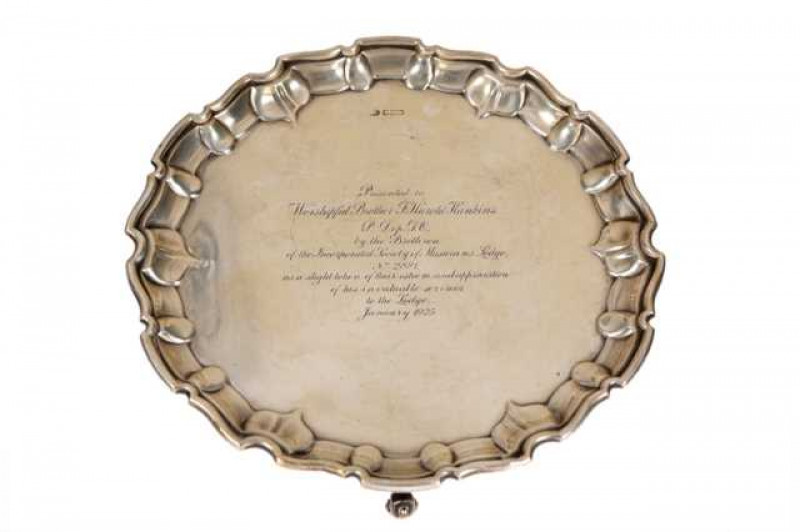 A George V silver salver, John Round, Sheffield 1923, with pie crust rim, raised on scroll feet, with presentation inscription dated 1925. Approximately 18 troy ozs, 25cm