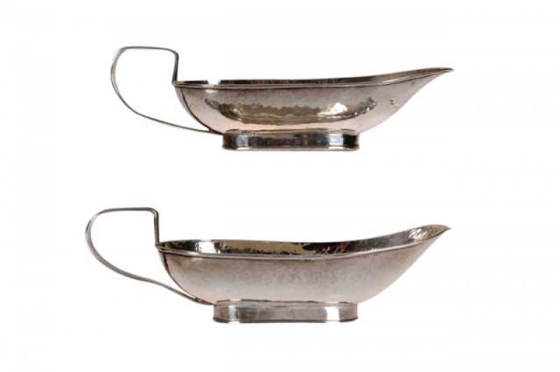 A pair of planished and stylised sauce boats, maker P.W., stamped SILVER. Approximately 9 troy ozs, 22cm