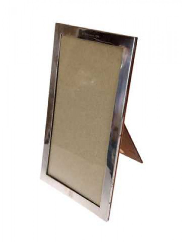 A large George V silver photograph frame, William Neale & Sons Ltd, Birmingham 1917, of plain rectangular easel form, engraved with a monogram and dated 15TH DECEMBER 1919. 32cm by 19.5cm