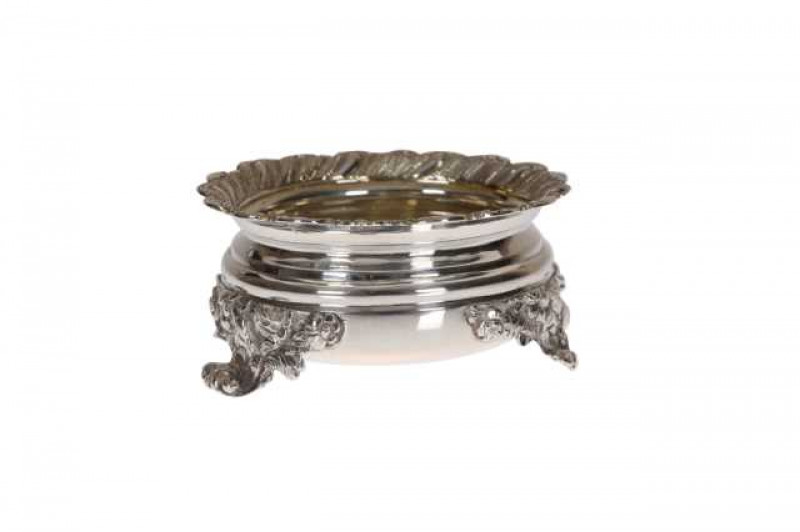 A George IV silver salt, London 1822, probably Jonathan Hayne, circular, the rim boldly cast with gadrooning, raised on three acanthus cast feet, engraved with initials to the underside. Approximately 3.5 troy ozs, 4cm by 9cm