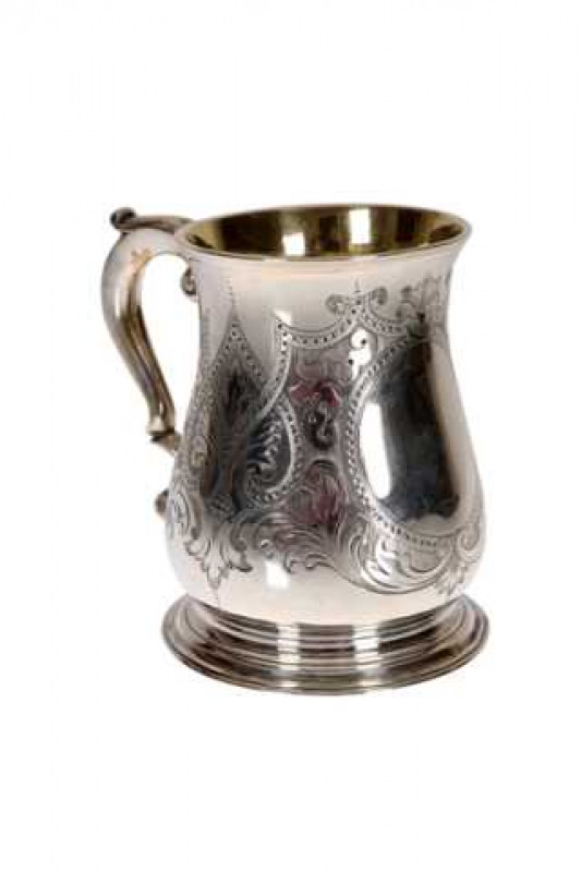 A George III silver baluster tankard, Richard Gurney & Co, London 1784, later engraved with formal scrolling foliage and a vacant cartouche, raised on a moulded circular foot. Approximately 13 troy ozs, 12cm