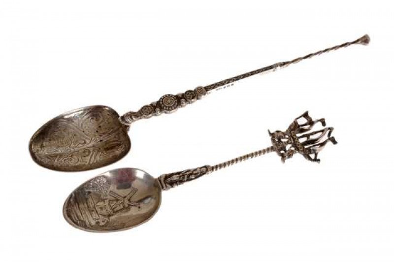 A George V silver copy of The Coronation anointing spoon, Levi & Salaman, Birmingham 1910, the bowl engraved with formal scrolling foliage below a tapering stem, 25.5cm; together with a George V silver spoon, Charles Hanbury-Tracy, London 1912, the bowl c
