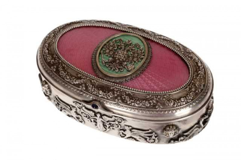 A fine Russian silver and enamel box, Moscow 189?, maker EK, assay master A.C., the pink engine turned enamel inset hinged oval cover centred by a green enamel oval panel applied with the double headed eagle and applied with a cabochon sapphire 'button', 