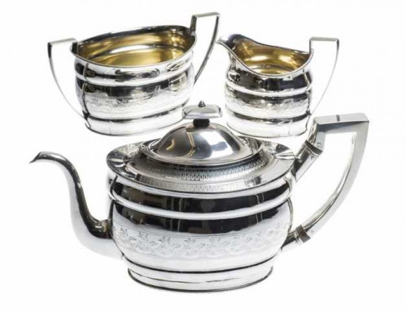 A George III silver three piece tea service, Richard Morton, Sheffield 1801 and 1802, comprising teapot, cream jug and two handled sugar bowl, with ropework rims and bands of bright cut foliate engraving. Total weight approximately 41 troy ozs, 32cm