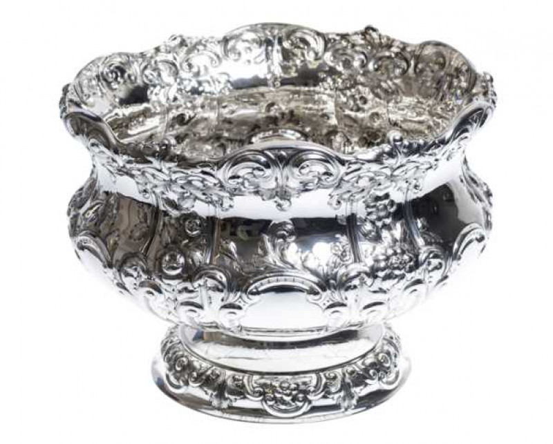 An impressive late Victorian silver bowl, Horace Woodward & Co Ltd, London 1900, the waisted body boldly embossed with C-scrolls and foliage, raised on a similarly decorated stepped foot. Approximately 65 troy ozs, 25cm by 34cm