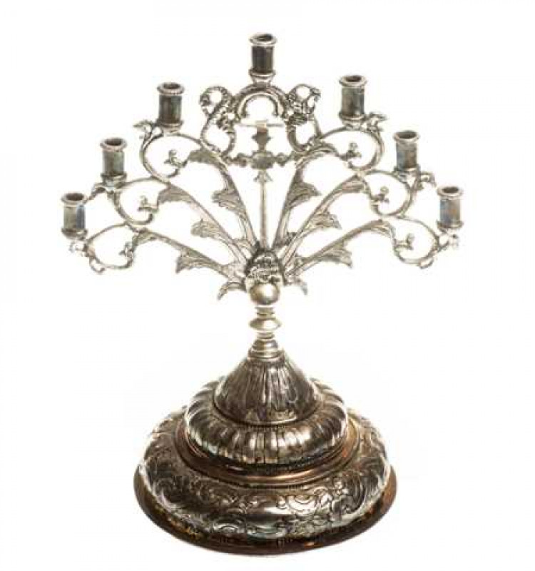 A Continental silver Menorah, probably German and 19th century, with seven candle cups and a domed base chased with scrolls and foliage, stamped marks to rim. Approximately 14 troy ozs, 24.5cm