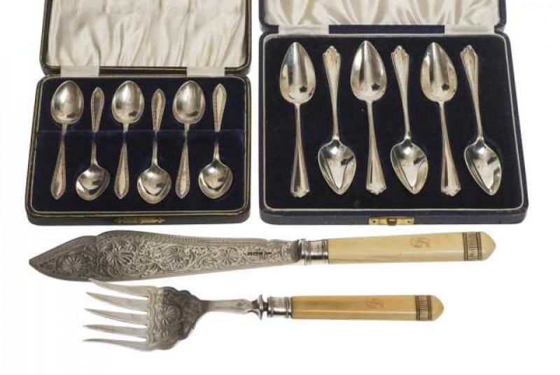 A pair of late Victorian silver fish servers, Walker & Hall, Sheffield 1899, with carved and monogrammed ivory handles, engraved with foliage; together with a set of six silver grapefruit spoons, London 1931, cased; and a set of six silver teaspoons, Lond