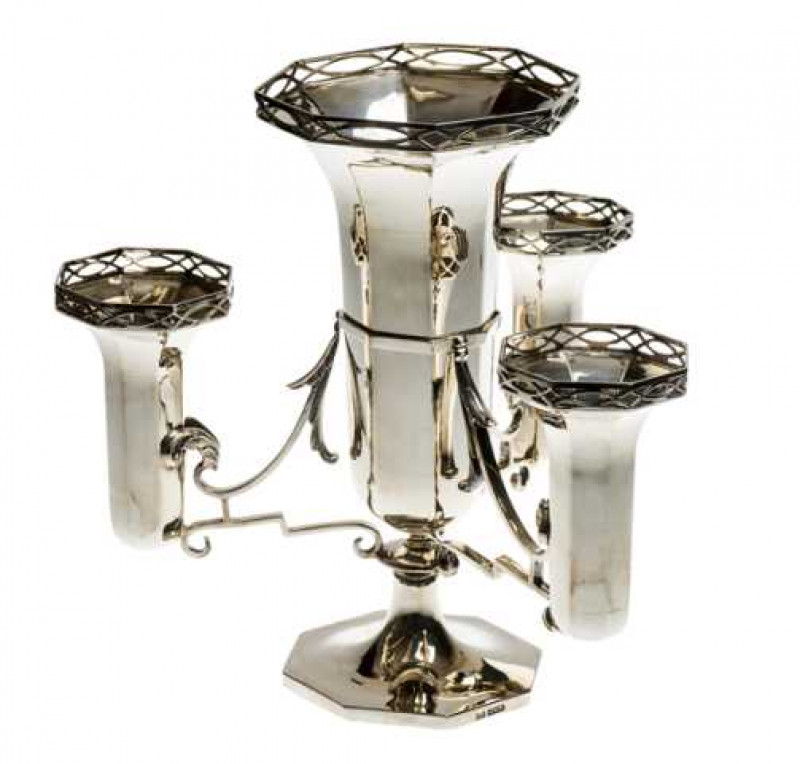 A George V silver epergne, Walker & Hall, Sheffield 1917, the central faceted vase with pierced rim, surrounded by three smaller conforming vases, raised on a stepped octagonal foot. Approximately 31 troy ozs, 26cm