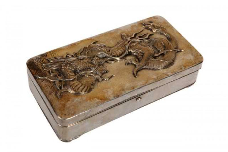 Arthur & Bond, Yokohama: A Japanese sterling silver box, rectangular with rounded corners, embossed with a dragon to the hinged cover, hammered finish, velvet lined interior. Approximately 13.4 troy ozs, 18cm by 9.5cm