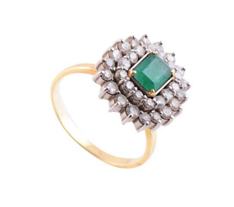 An emerald and diamond ring, the central square cut emerald four claw set within an inner bezel of fourteen brilliant cut claw set diamonds, in turn within an outer bezel of eighteen further brilliant cut claw set diamonds, all set on a pierced open mount