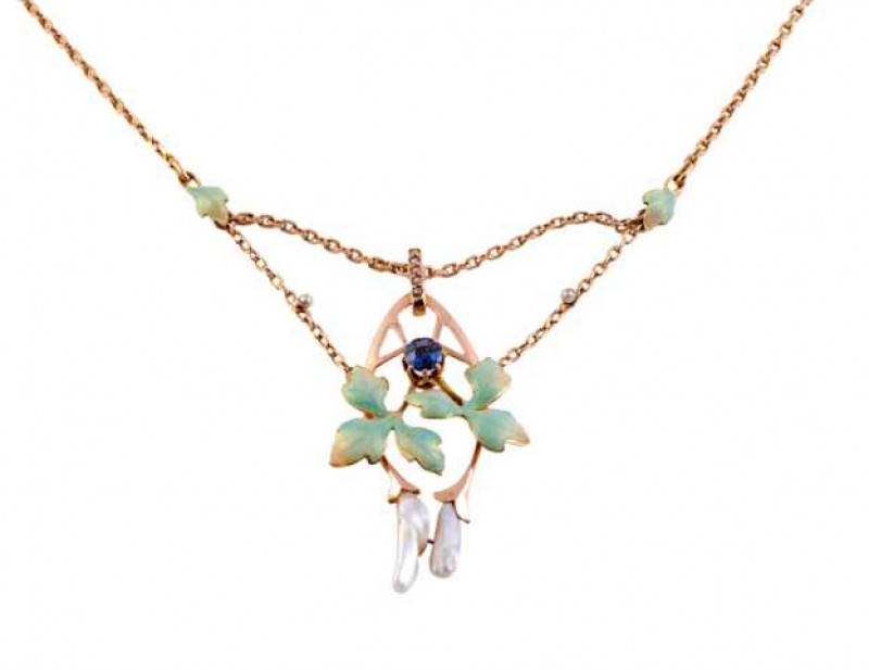 An Art Nouveau enamel, cultured pearl and sapphire pendant, the pierced oval shaped drop set to the centre with a round cut eight claw set sapphire to the top of two three-leaf shaped mounts set with pale green guilloche enamel, in turn to the top of two 
