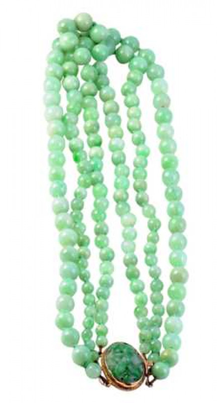 A jadeite necklace, the three graduating rows of graduating jadeite beads strung onto an oval integral tongue clasp with ropework detailing to the bottom, set with a collet set pierced jadeite plaque, carved to depict a flowerhead. 105 beads in total. Wei