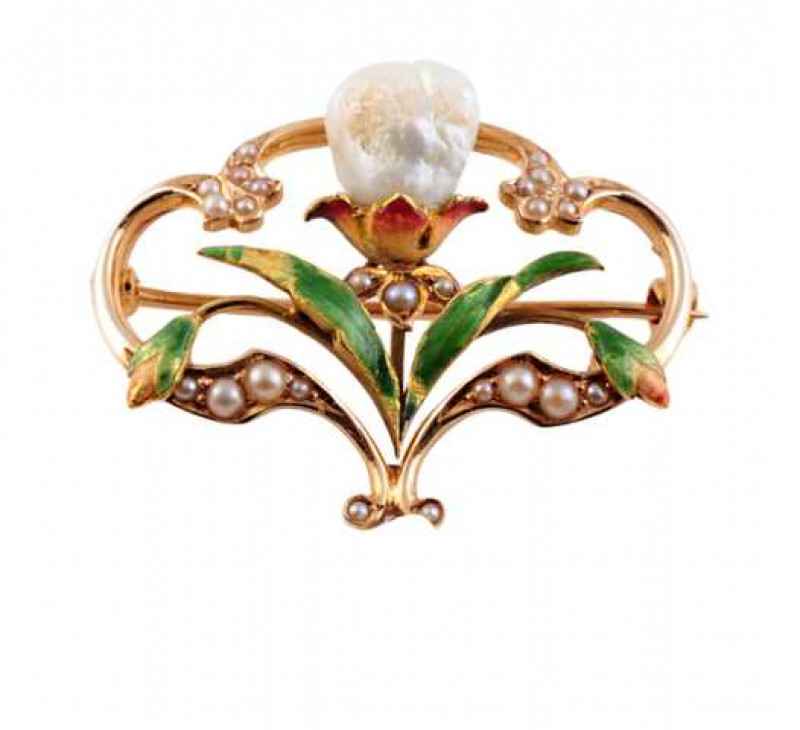 An Art Nouveau seed pearl, cultured baroque pearl and enamel brooch, the delicate design set throughout with graduating seed pearl highlights to the out edge of the mount, a large baroque pearl sitting to the top of a three petal shaped mount with delicat