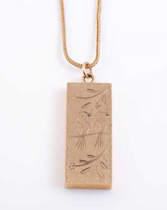 A 9 carat gold ingot pendant, hallmarked Birmingham 1978, on a 9 carat gold chain. Total weight approximately 33 grams