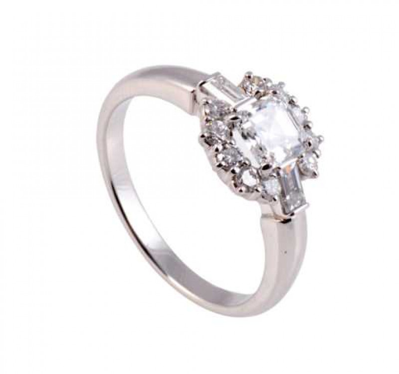 A diamond ring, the central asscher diamond four claw set between two baguette cut diamonds set horizontally on the shoulders, all within a surround of ten brilliant cut claw set diamonds, in a pierced mount on a plain band. Ring size O.