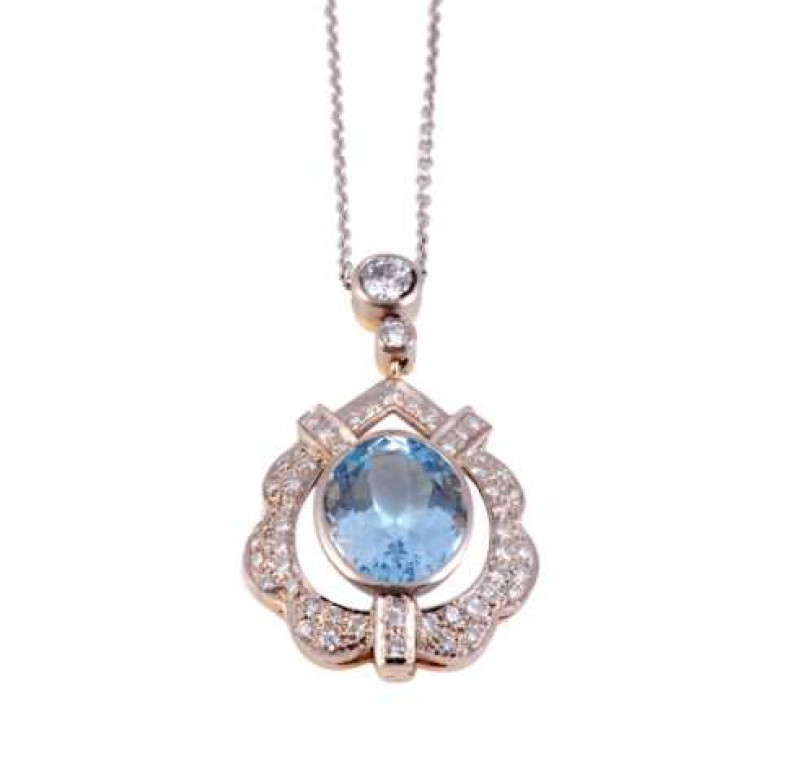 An aquamarine and diamond pendant, the central oval cut aquamarine collet set to the centre of an open and moulded mount set throughout with graduating brilliant cut diamond highlights, suspending on an articulated link from a smaller collet set brilliant