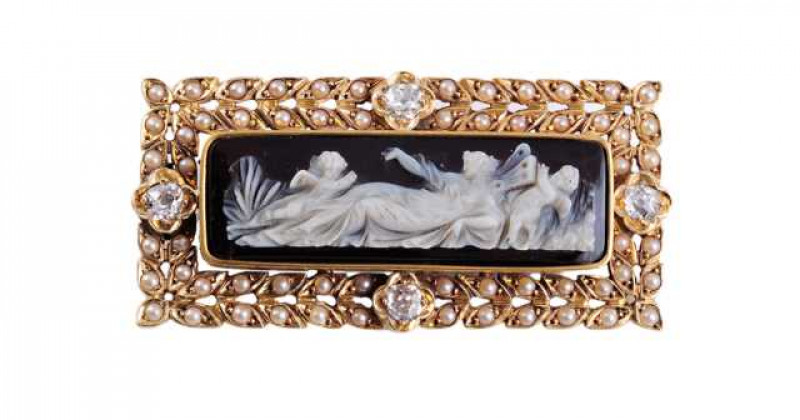 A Victorian seed pearl and diamond cameo brooch, the rectangular cut cameo depicting a reclining maiden and cherubs, in a collet setting raised above a mount designed as individual leaves, each set with a single seed pearl highlight to the centre and four