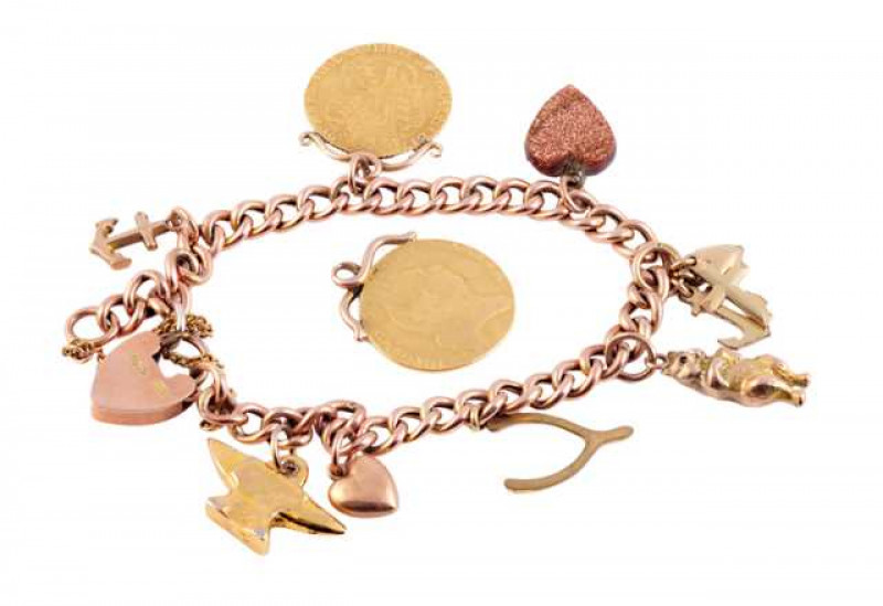 A Victorian rose gold charm bracelet, including a George III spade half guinea and a George III rose half guinea, some charms not gold. Total weight approximately 27.5 grams