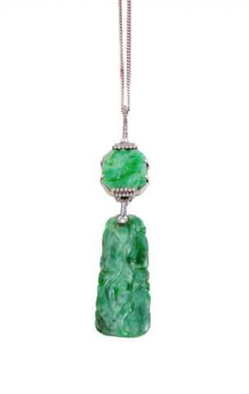 A jade and diamond pendant, the subtly carved rectangular shaped plaque suspending from an oval shaped bale set with seven brilliant cut diamond highlights, in turn suspending from a square shaped jade plaque four claw set, set to the top and bottom with 
