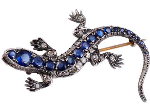 A sapphire and diamond brooch, modelled as a lizard, the realistic design...